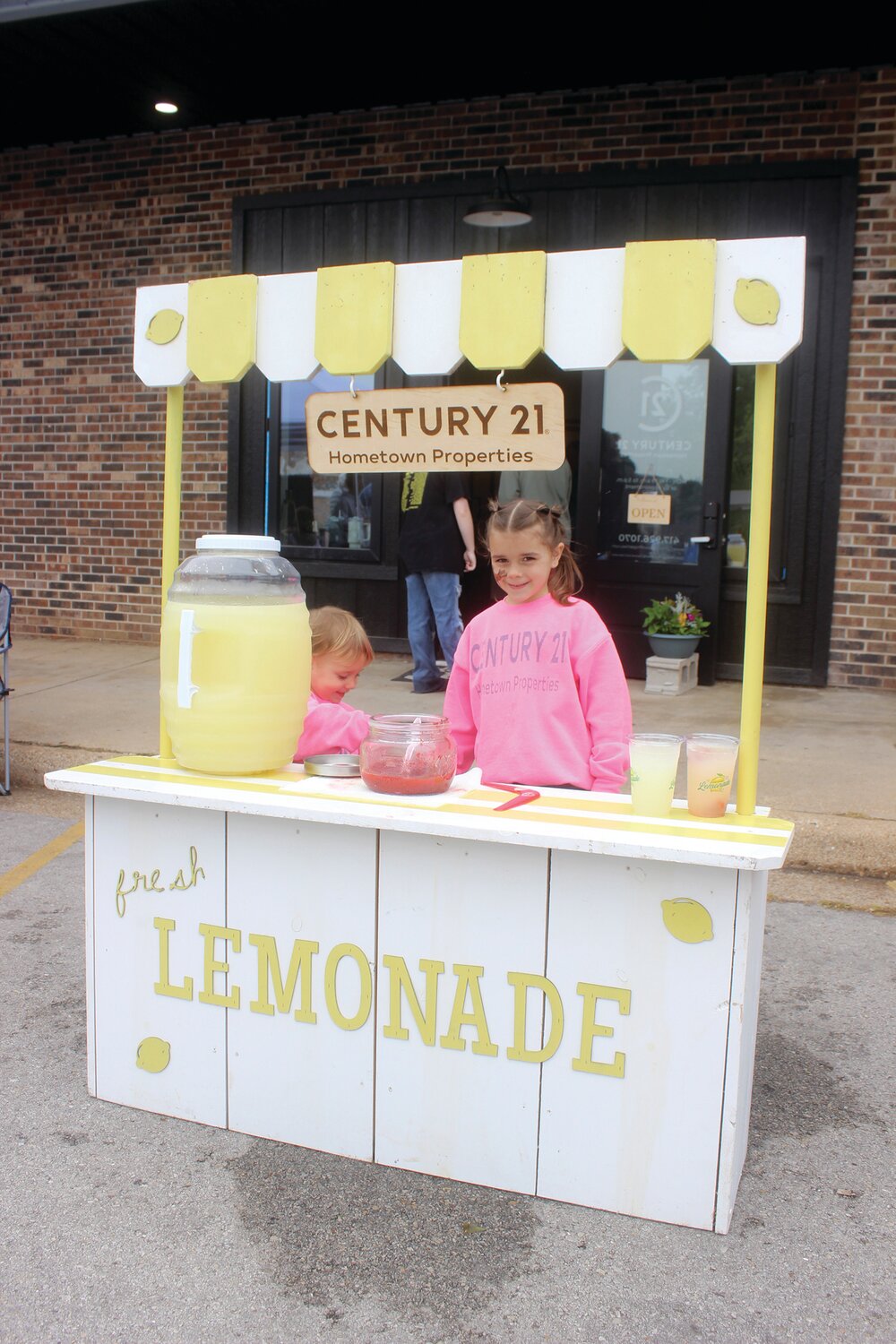 Scout and Saylor Beller work a Lemonade stand during Mayfest.